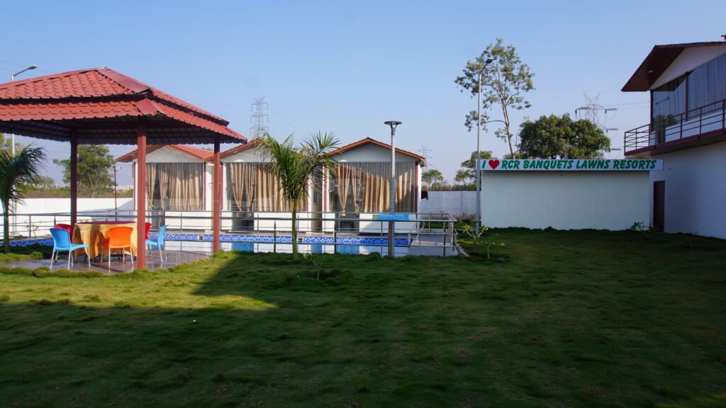 The best farmhouse for birthday party in Hyderabad featuring a private swimming pool, lawn area, and outdoor gazebo seating.